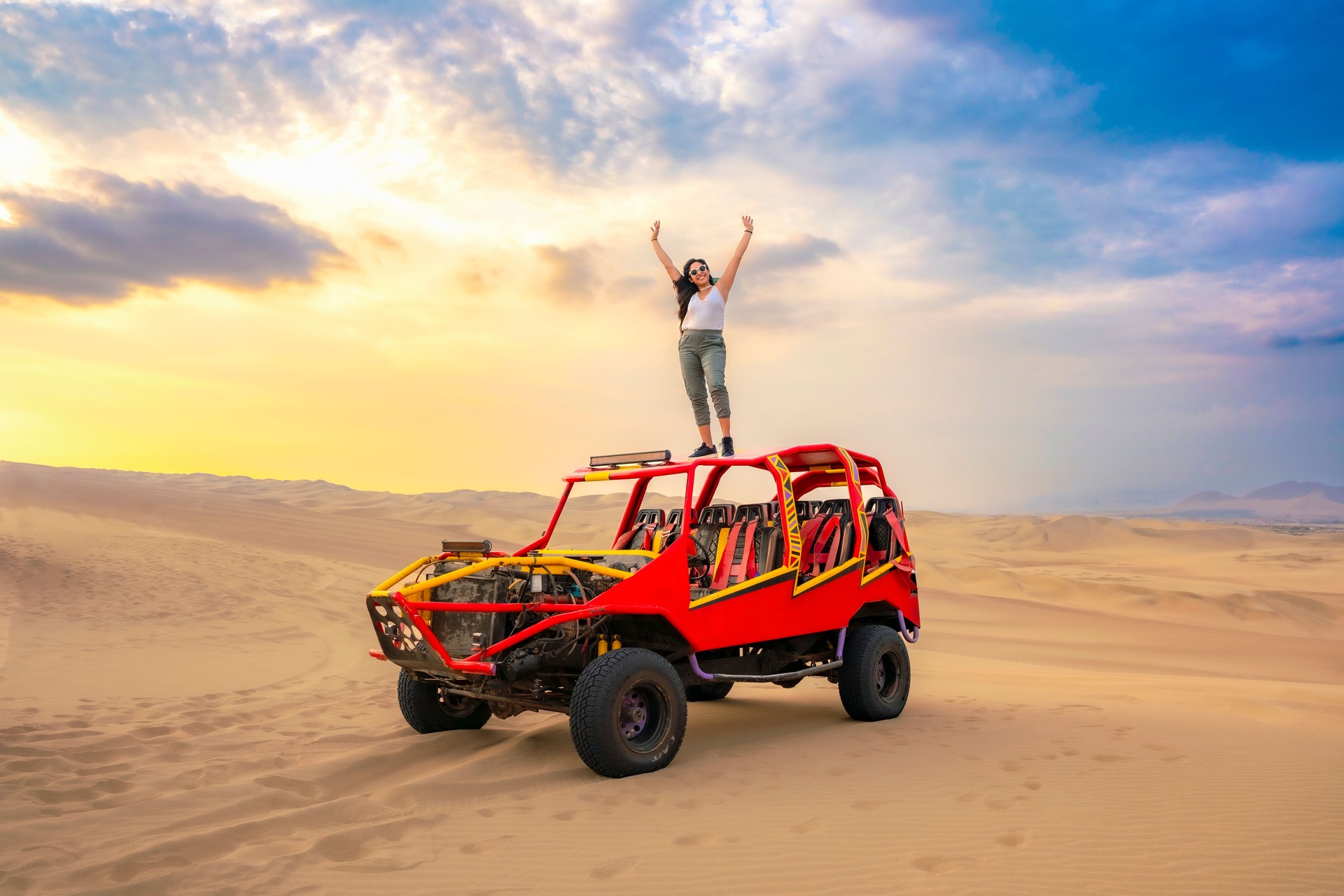 Woman Celebrating on Dune Buggy in Huacachina